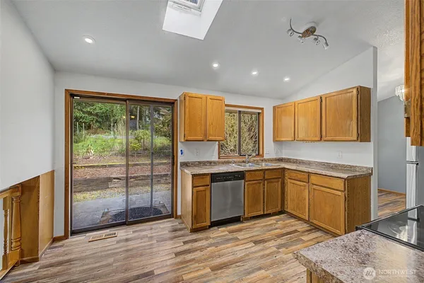 a kitchen with stainless steel appliances granite countertop a stove and cabinets