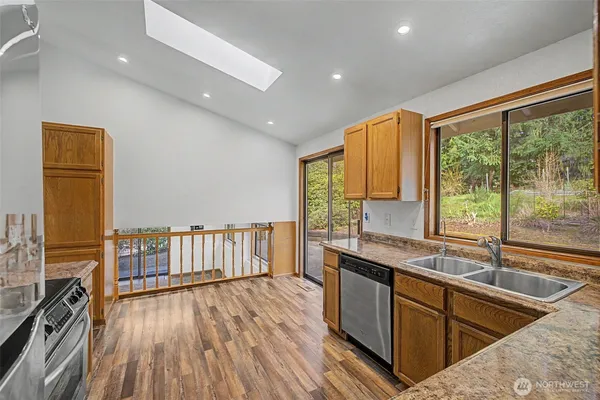 a kitchen with a sink and wooden floor