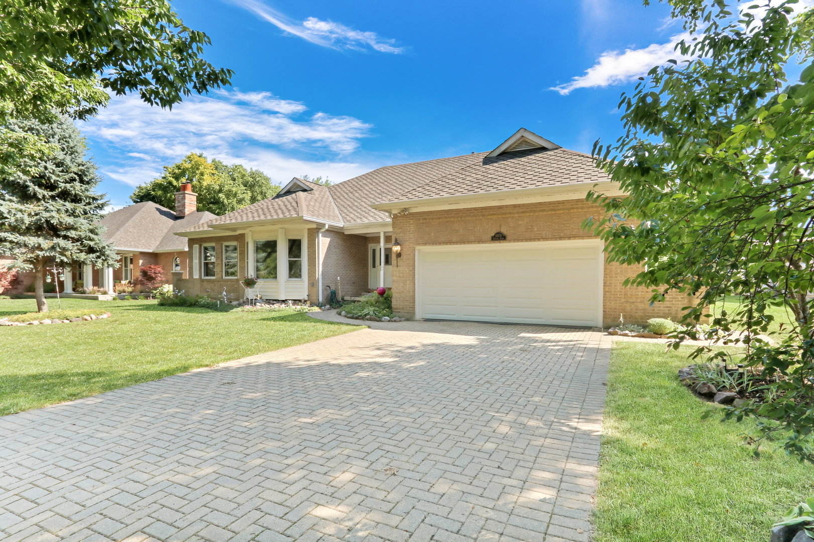 a front view of a house with a yard and garage