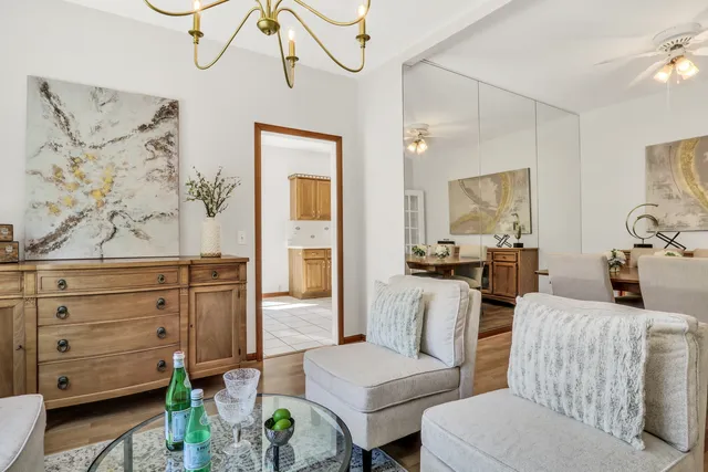 a living room with furniture and a painting on the wall