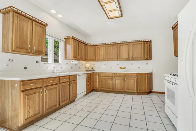 a kitchen with stainless steel appliances a stove sink and cabinets