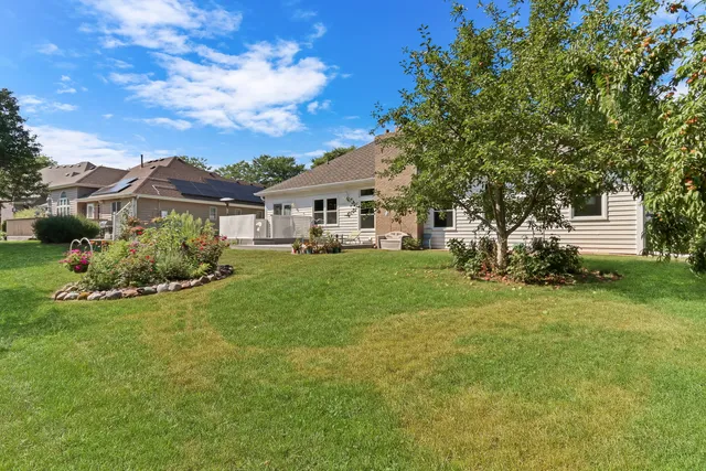 a view of a house with a big yard and large trees