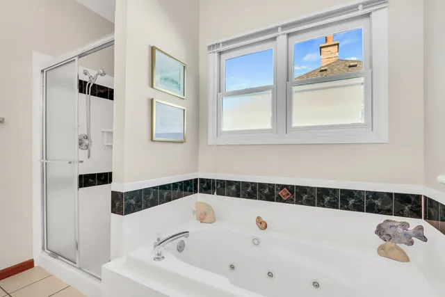 a bathroom with a bathtub and a shower
