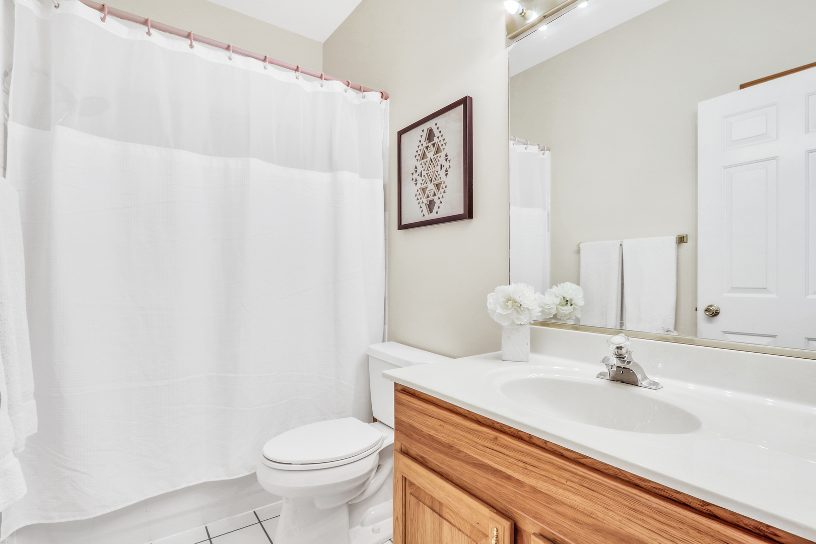 1075 Suffolk Court Gurnee, IL 60031 - Photo 37 of 51 a bathroom with a sink a toilet and mirror