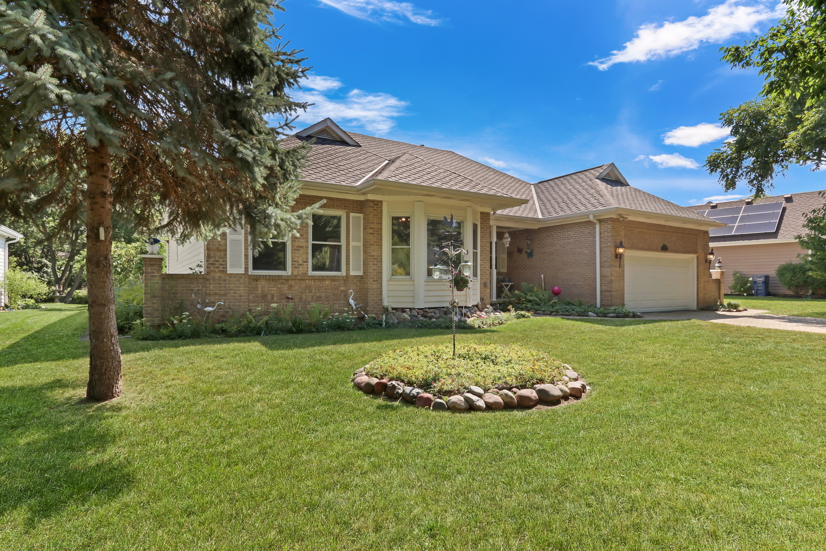 1075 Suffolk Court Gurnee, IL 60031 - Photo 40 of 51 a view of a white house with a small yard and large tree