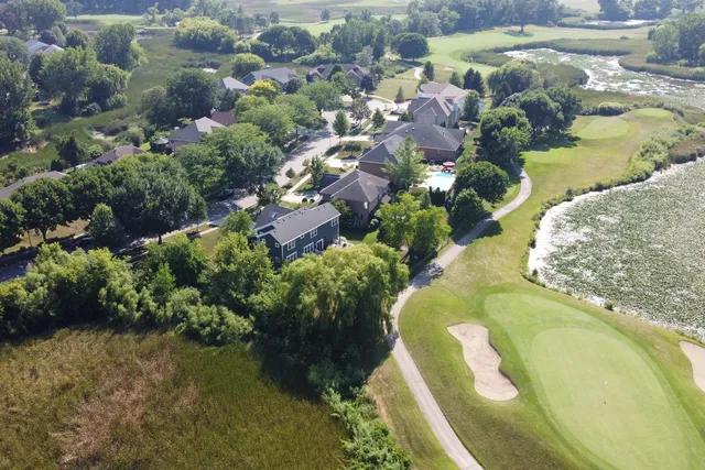 an aerial view of residential houses with outdoor space