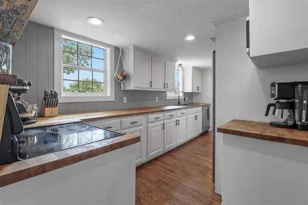 a kitchen that has a sink a window and stainless steel appliances