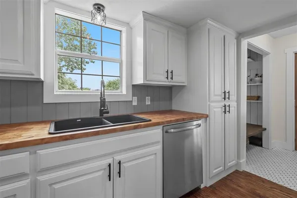 a kitchen with stainless steel appliances granite countertop a sink and a window