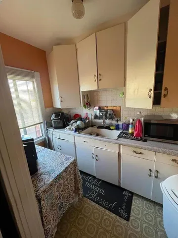a kitchen with a sink and cabinets