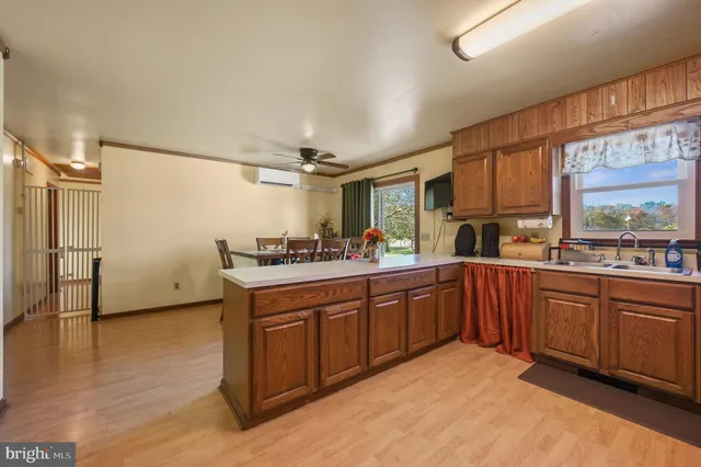 a kitchen with stainless steel appliances granite countertop a sink and wooden cabinets