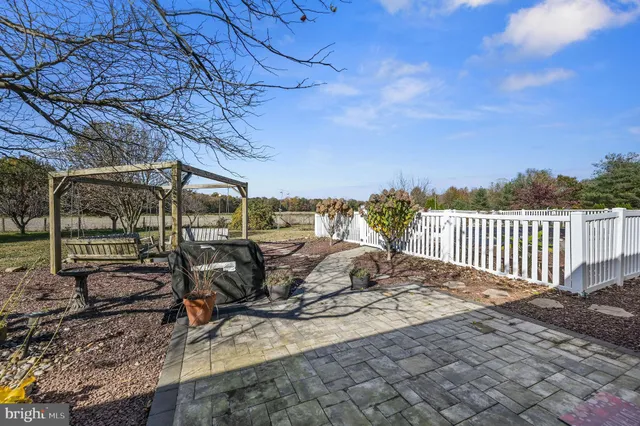 a view of a patio with a table and chairs
