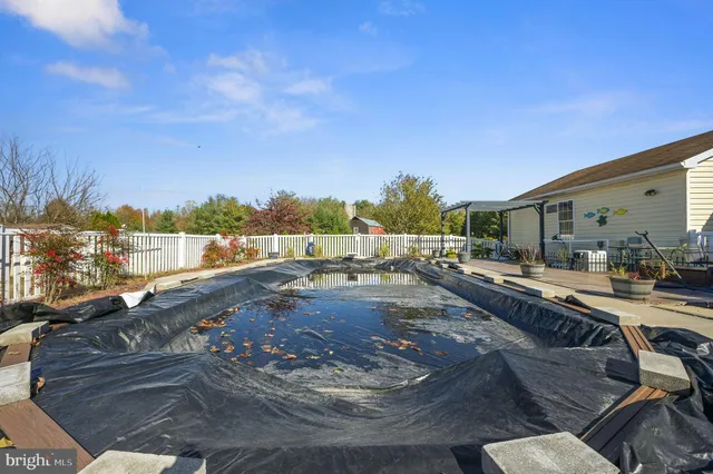 a view of a swimming pool with an outdoor seating
