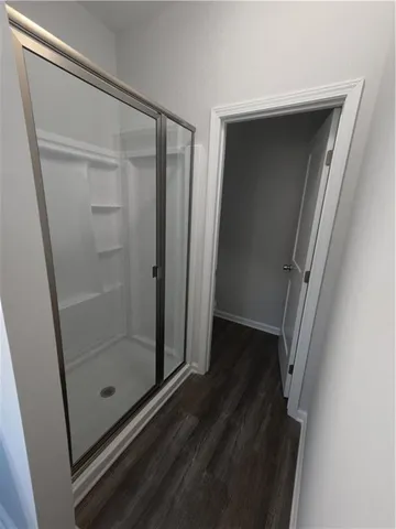 a bathroom with a glass door shower