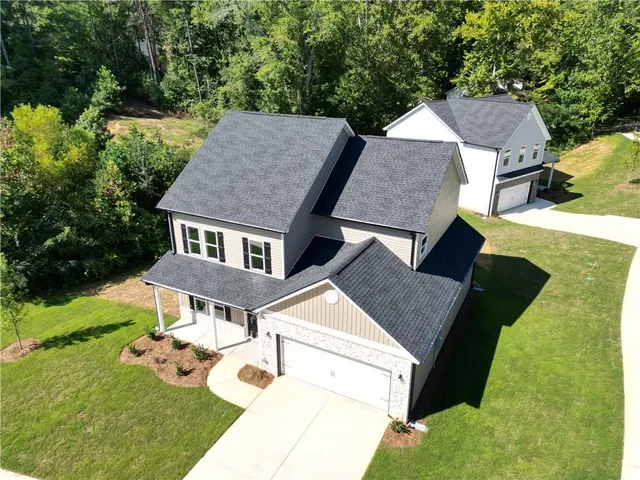 a aerial view of a house with yard and patio