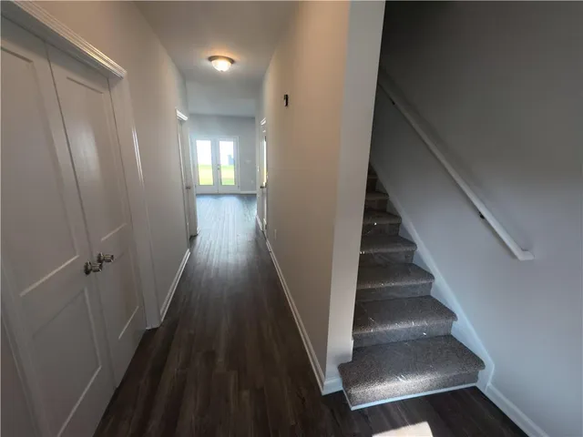 a view of entryway and hall with wooden floor