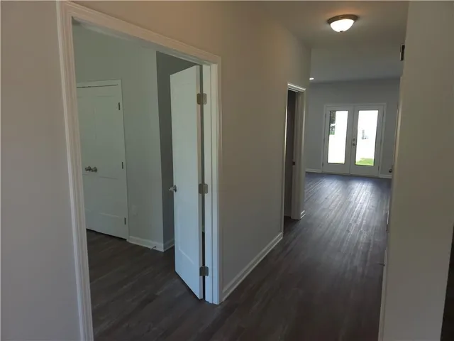 a view of a hallway with wooden floor