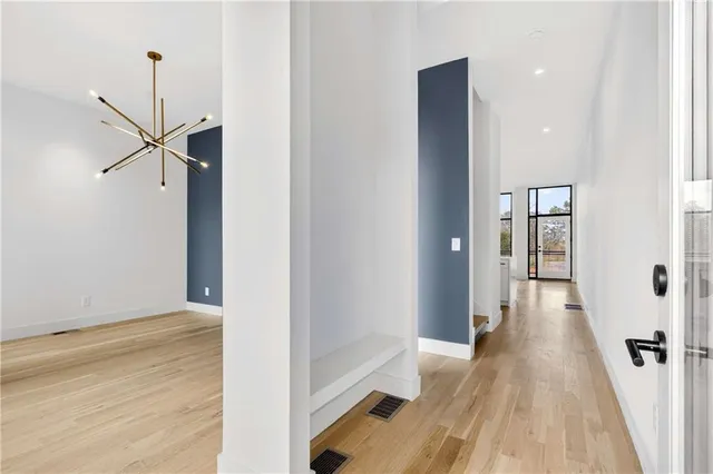 a view of hallway with wooden floor