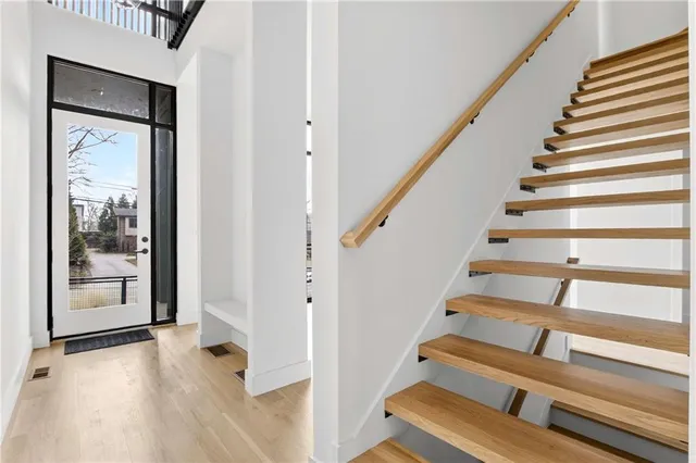 a view of entryway with wooden floor and door