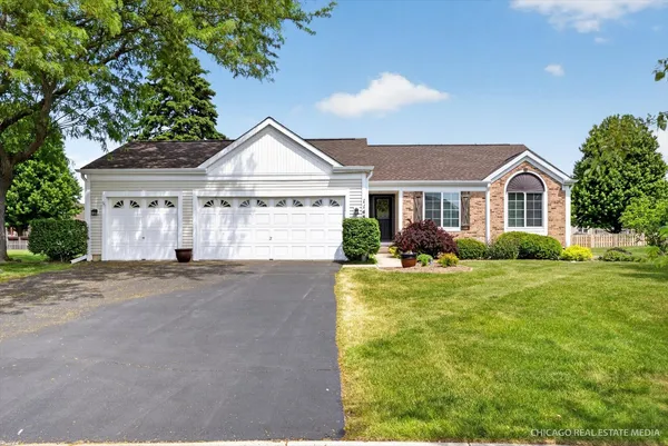 a front view of a house with a yard and garage