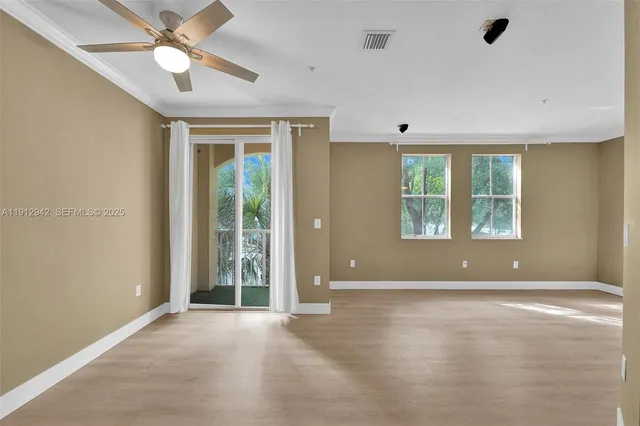 a view of an empty room with a fan