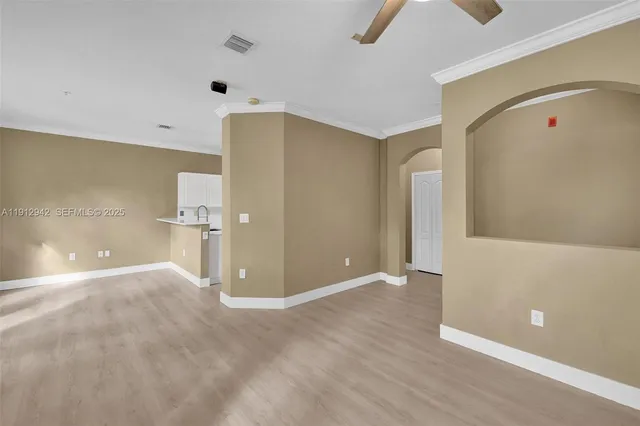 a view of a kitchen with a sink and a refrigerator