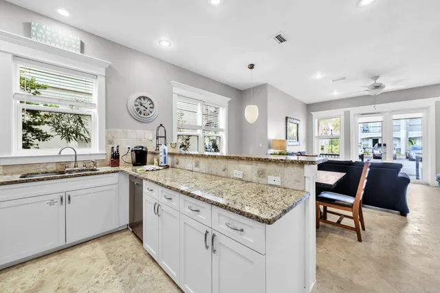 a kitchen with center island table and chairs