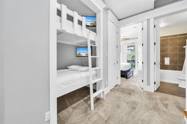 a bedroom with a bed dresser and a window