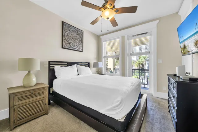 a large bedroom with wooden floor and window