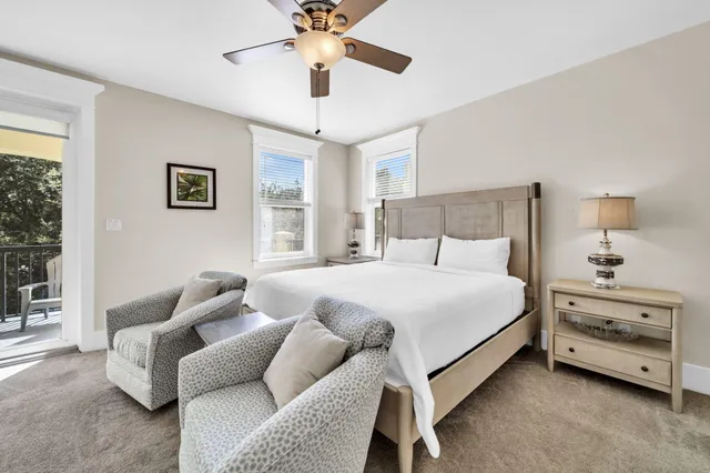 a spacious bedroom with a large bed and a chandelier