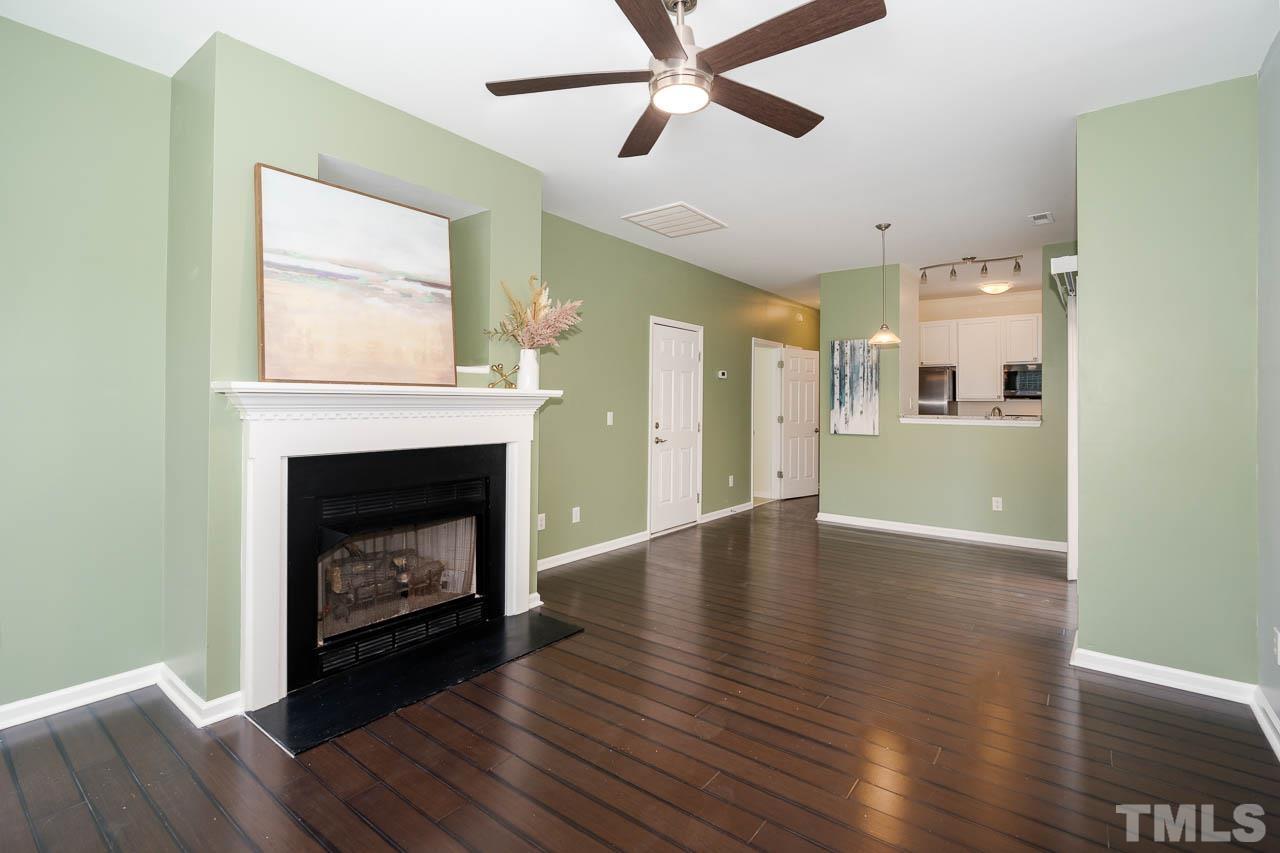 1917 Barngate Way Raleigh, NC 27614 - Photo 2 of 10 a view of a room with wooden floor a fire place and a fireplace
