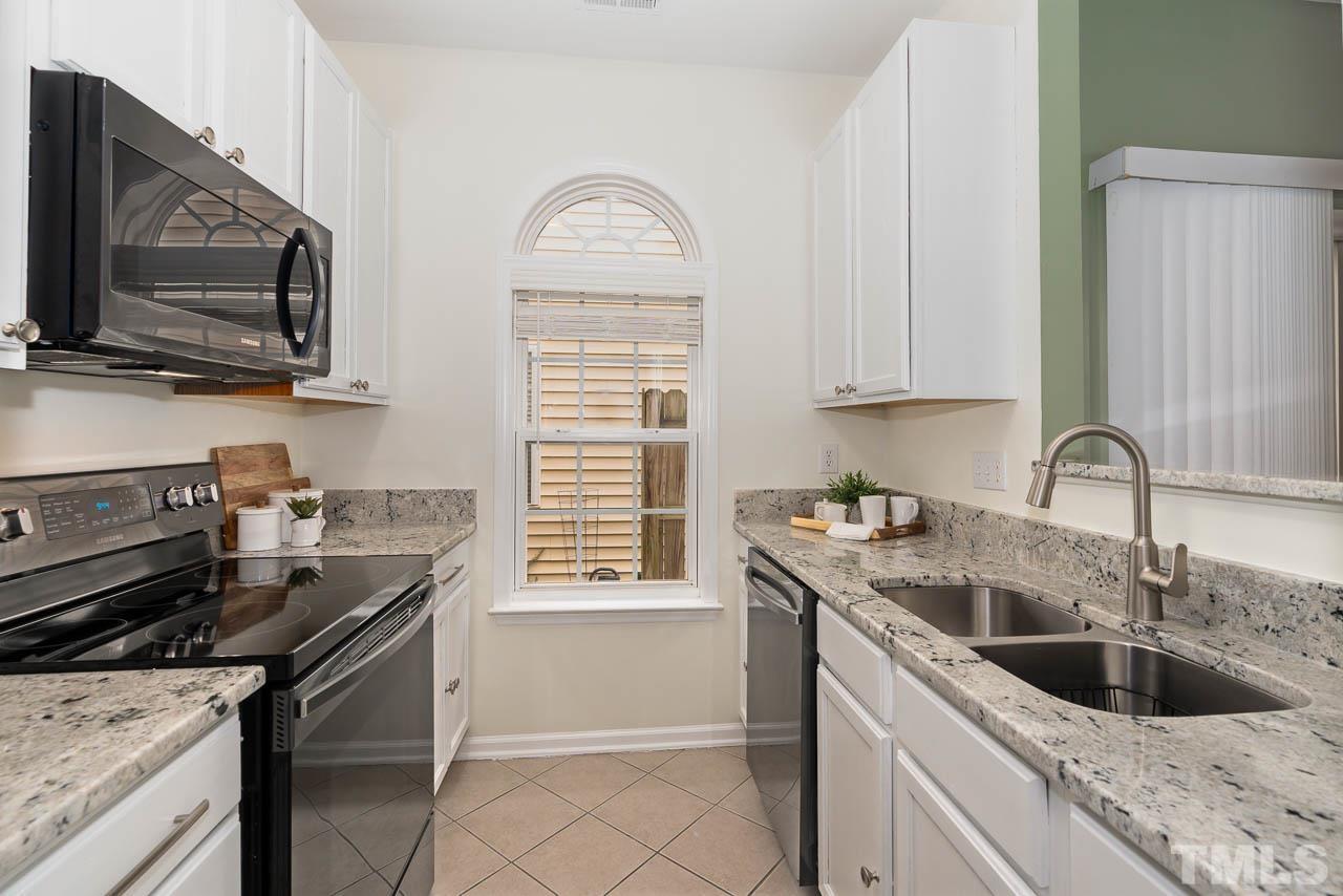 1917 Barngate Way Raleigh, NC 27614 - Photo 3 of 10 a kitchen with a sink stove and microwave
