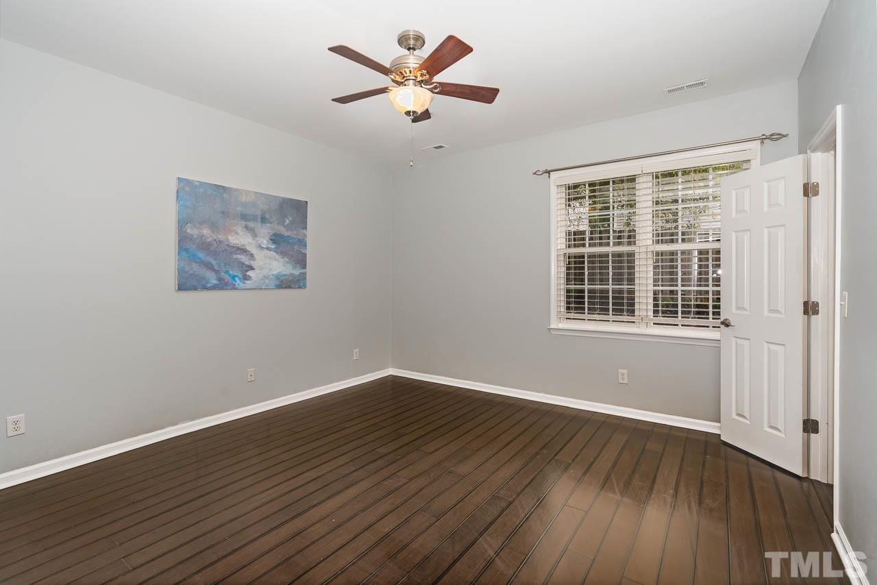 1917 Barngate Way Raleigh, NC 27614 - Photo 4 of 10 a view of a room with wooden floor and a ceiling fan