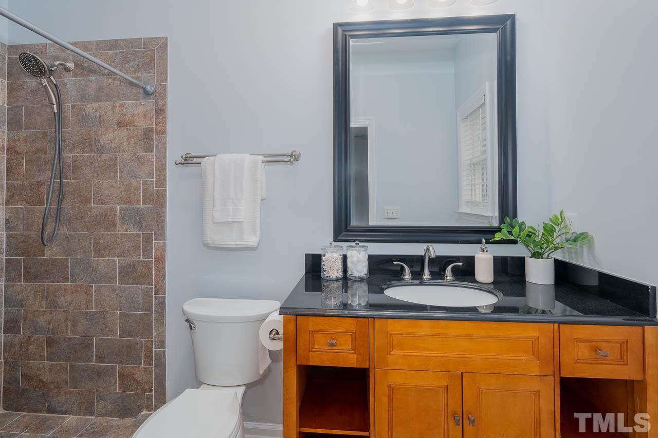 1917 Barngate Way Raleigh, NC 27614 - Photo 6 of 10 a bathroom with a granite countertop sink a toilet and mirror