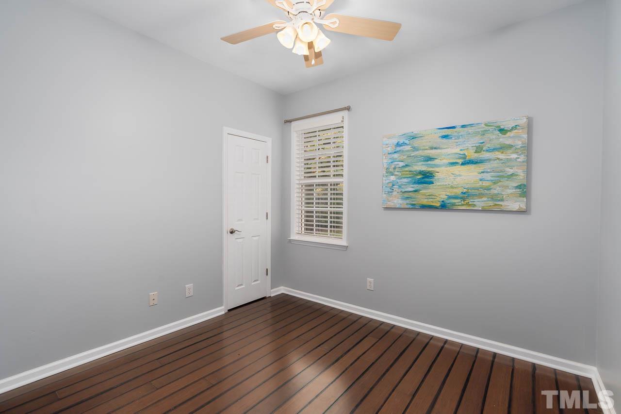 1917 Barngate Way Raleigh, NC 27614 - Photo 8 of 10 a view of an empty room with wooden floor and a window