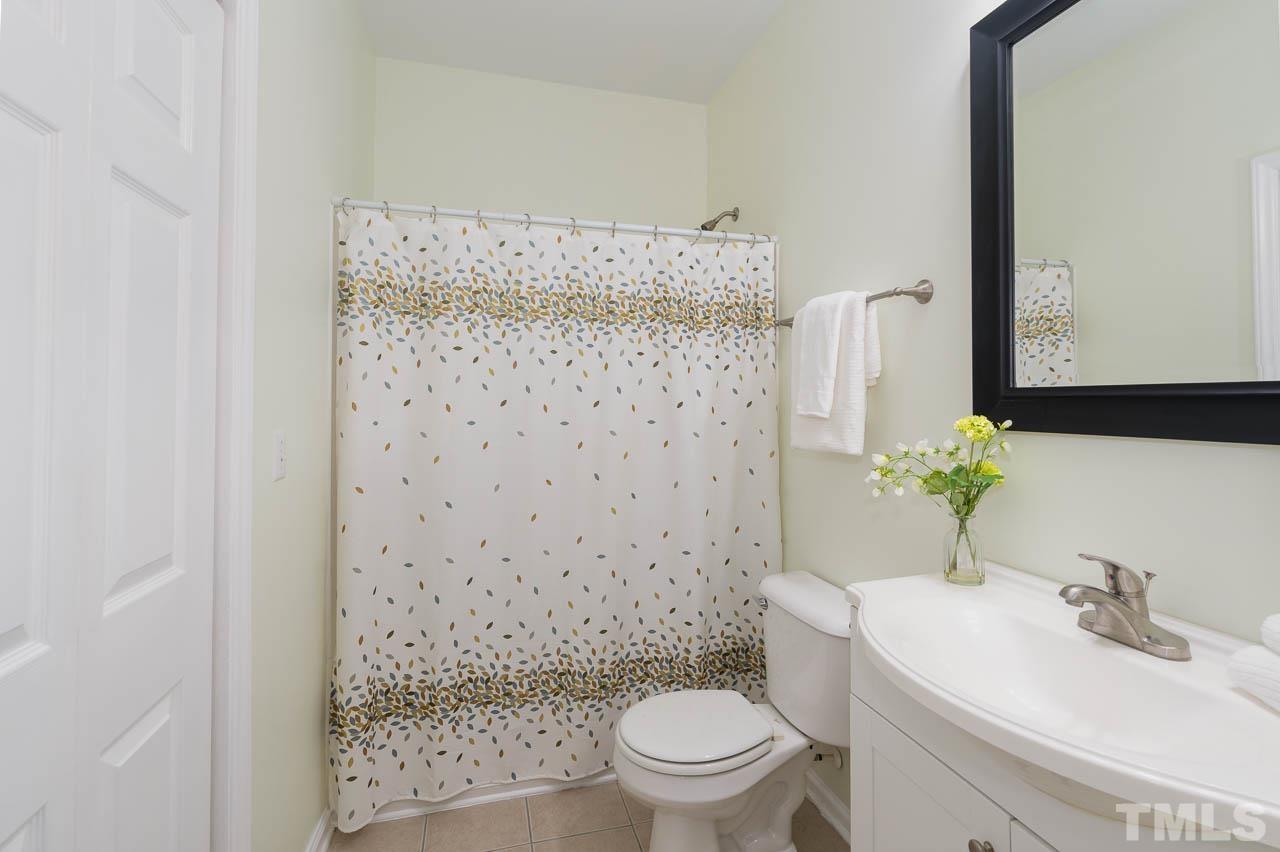1917 Barngate Way Raleigh, NC 27614 - Photo 9 of 10 a bathroom with a sink a toilet and shower