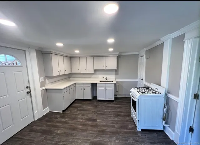 a kitchen with a refrigerator sink and wooden cabinets
