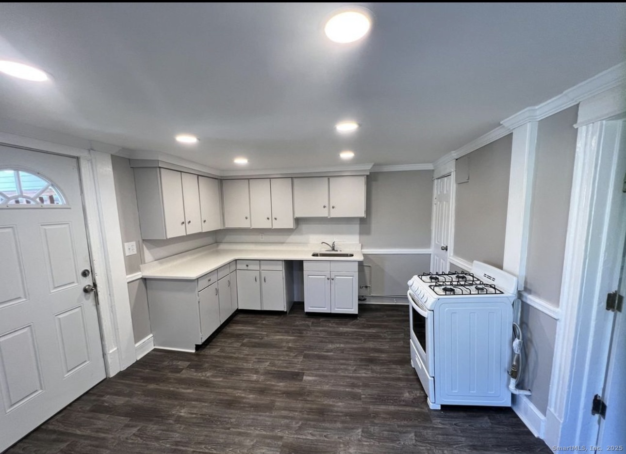 a kitchen with a refrigerator sink and wooden cabinets