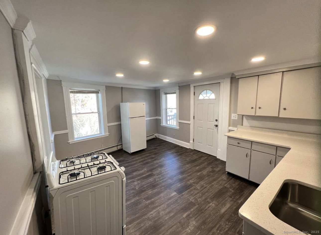 68 Anderson Street, Unit 3R Naugatuck, CT 06770 - Photo 2 of 6 a kitchen with refrigerator and white cabinets