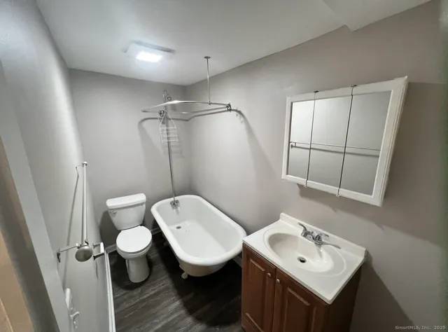 a bathroom with a toilet sink and mirror