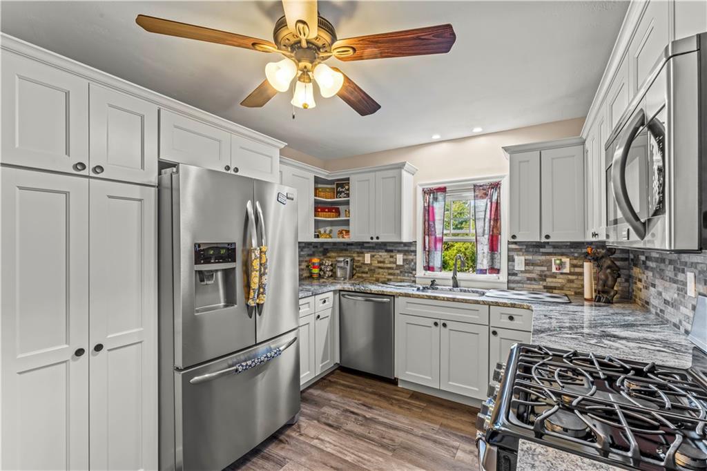 412 Center Church Road Canonsburg, PA 15317 - Photo 6 of 24 a kitchen with stainless steel appliances a refrigerator sink and cabinets
