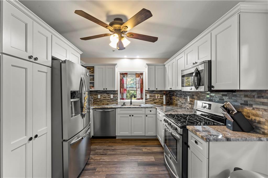 412 Center Church Road Canonsburg, PA 15317 - Photo 7 of 24 a kitchen with stainless steel appliances granite countertop a stove sink and refrigerator
