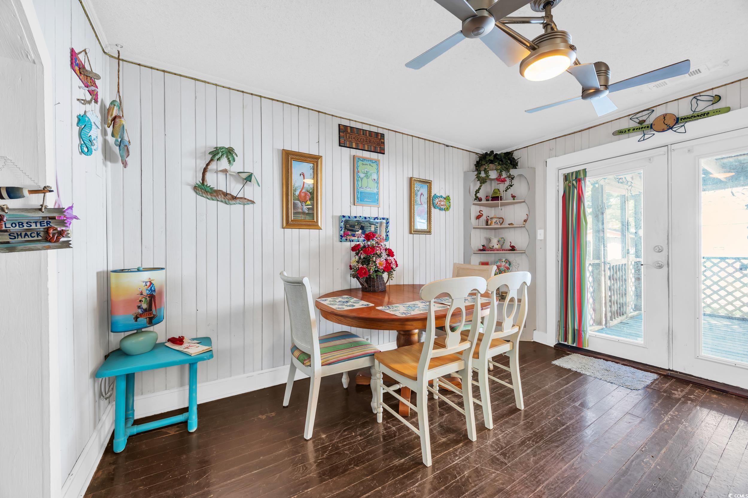 1616 Perrin Drive North Myrtle Beach, SC 29582 - Photo 13 of 40 Dining area with french doors, dark wood-style flooring, and wood walls