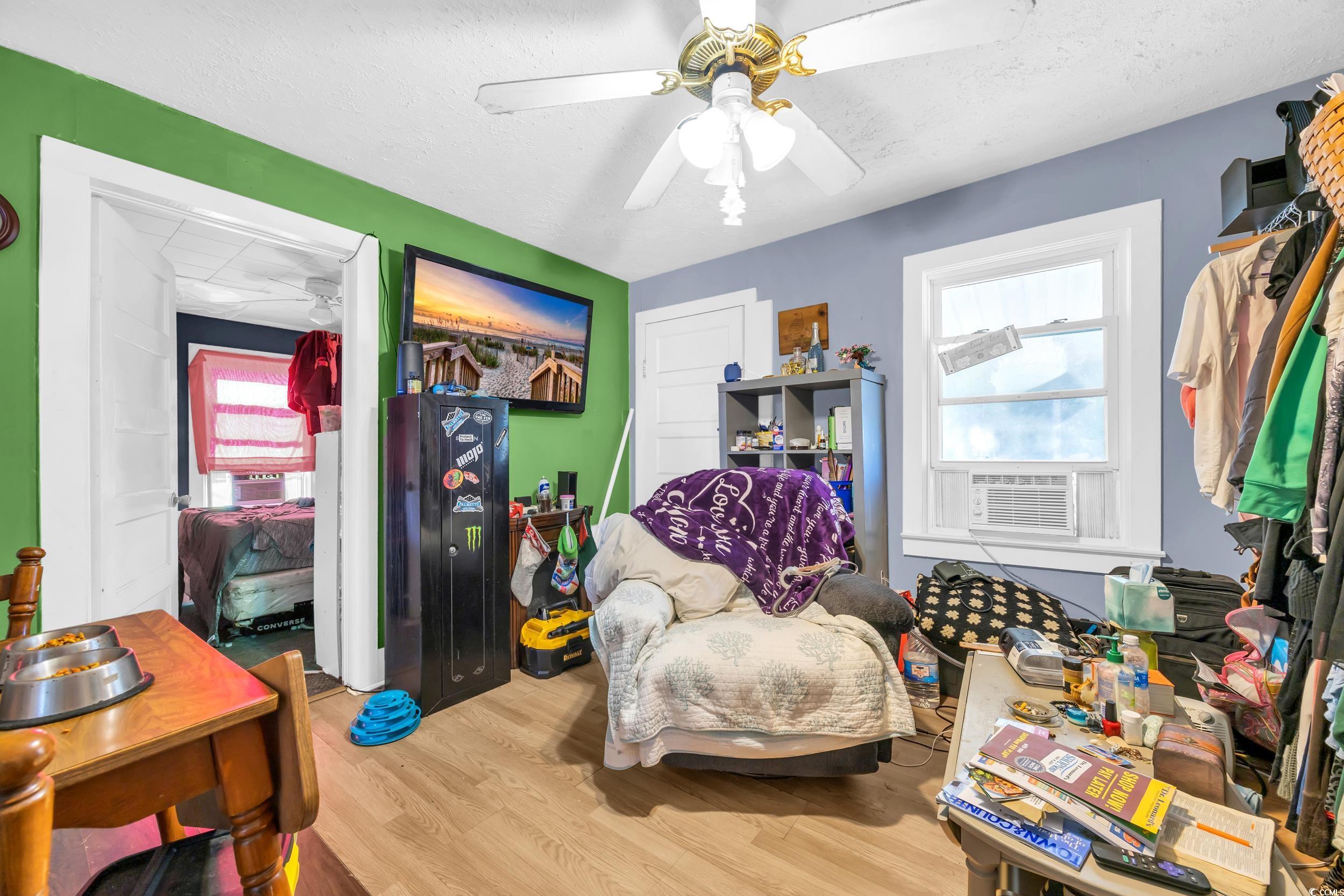 1616 Perrin Drive North Myrtle Beach, SC 29582 - Photo 33 of 40 Living area with wood finished floors, healthy amount of natural light, ceiling fan, a textured ceiling, and cooling unit