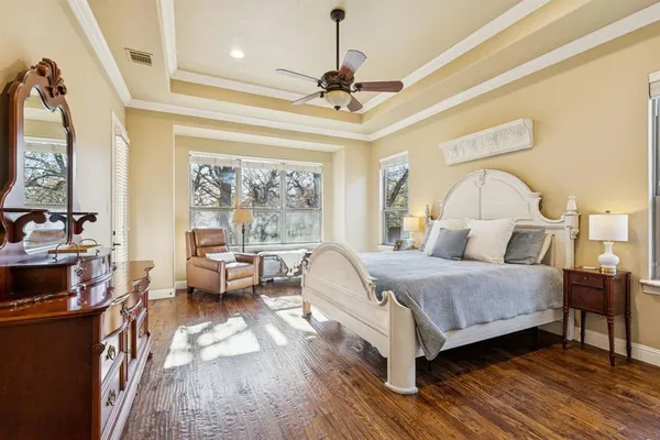 a bedroom with a bed and a chandelier