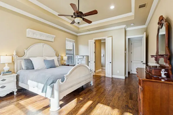 a spacious bedroom with a bed and a chandelier
