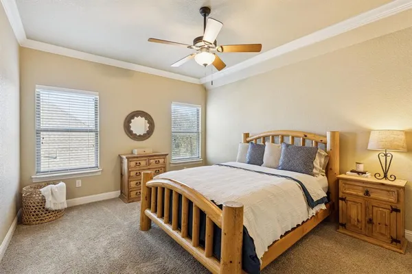 a bedroom with a bed a window and a chandelier