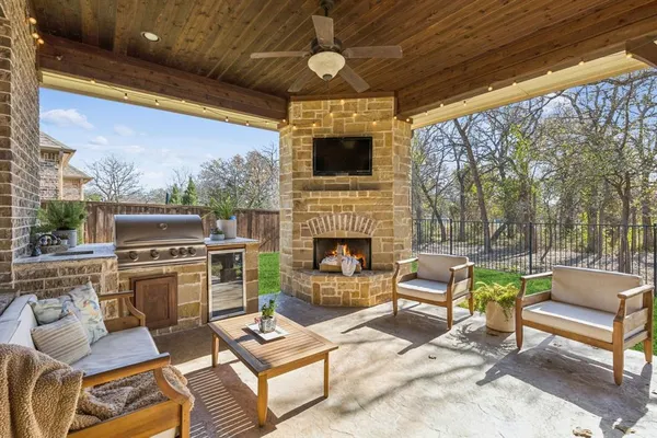a outdoor living space with patio furniture and a fireplace