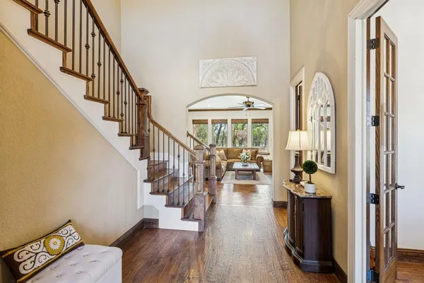 a view of a hallway with wooden floor fireplace and livingroom
