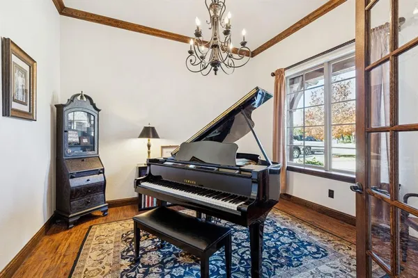 a living room with furniture a piano and a window