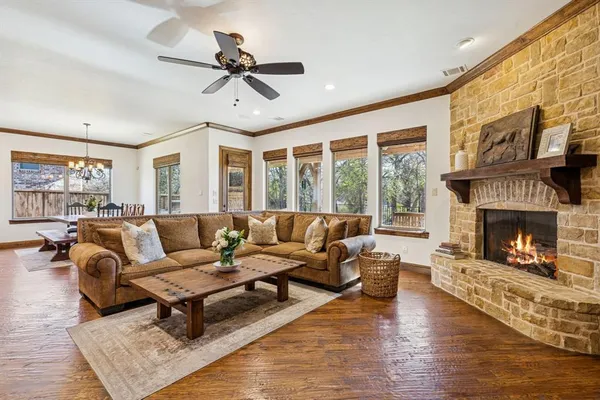 a living room with furniture fireplace and a large window